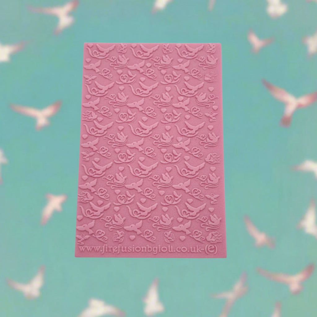 A lovebird pattern embossed texture mat. This texture mat will give you a debossed effect on metal clay or polymer clay.