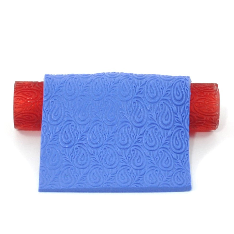 Blue polymer clay textured paisley on a white background