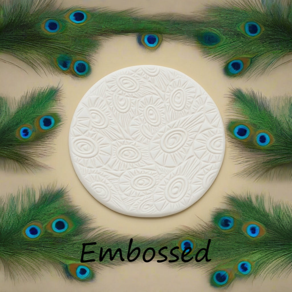 A peacock pattern debossed in clay using a patterned embossed texture mat. This will give you an idea of what it will look like on metal clay or polymer clay.