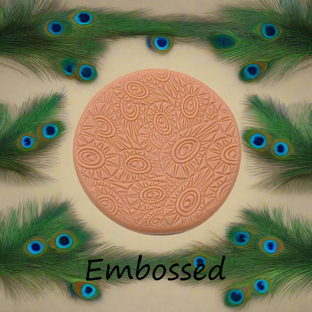 A peacock pattern debossed in silly putty Using a patterned embossed texture mat in grey material. This will give you an idea of what it will look like on metal clay or polymer clay.