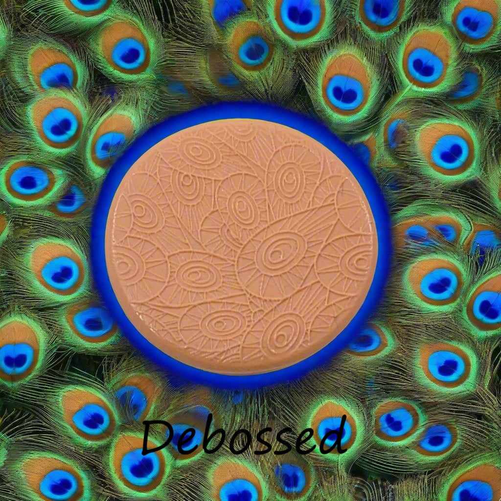 A peacock pattern embossed in silly putty Using a patterned debossed texture mat in grey material. This will give you an idea of what it will look like on metal clay or polymer clay.