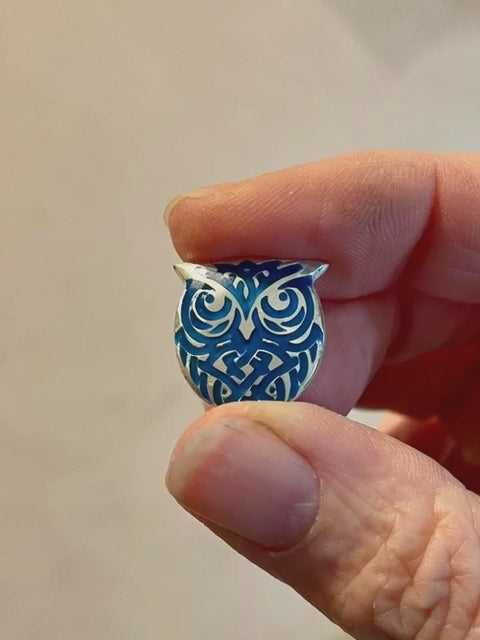 A Jewellery designer JewellerybyGem who is holding a little owl pendant in her fingers. The pendant transforms into a flying owl. 
