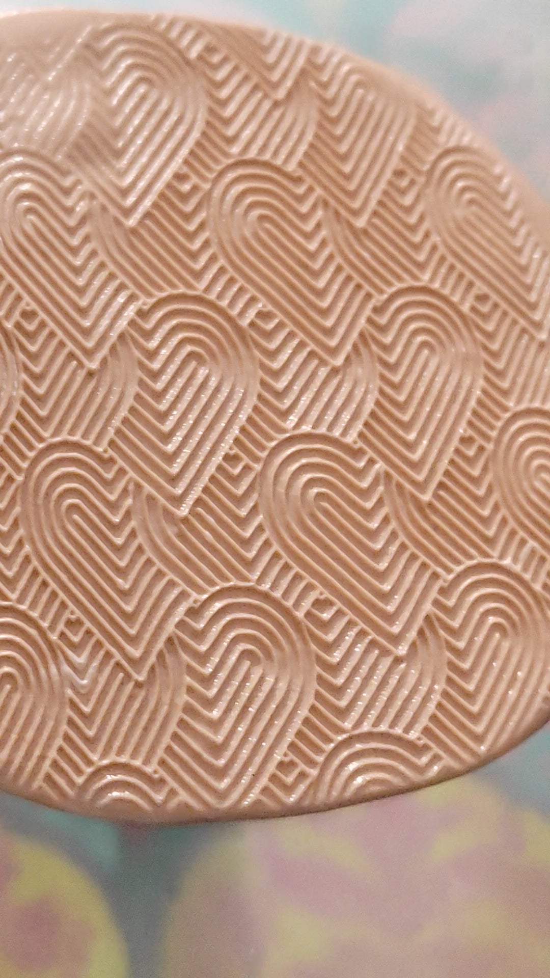Entwined hearts texture roller, rolled in silly putty.