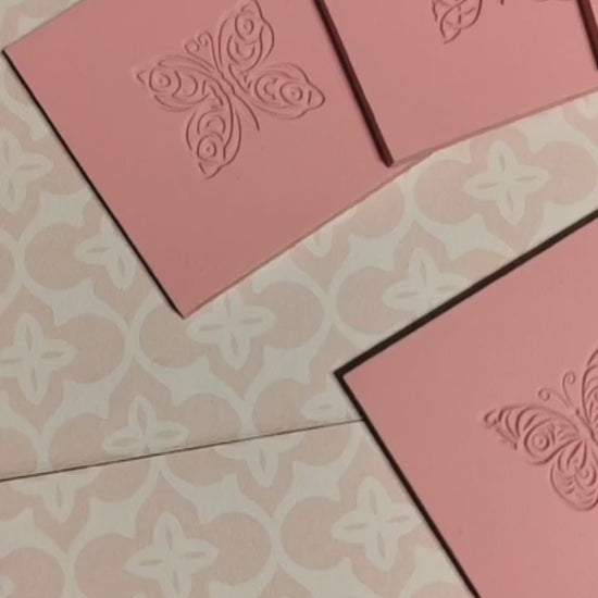 Mini butterfly texture mats In pink rubber displayed on a geometric background.