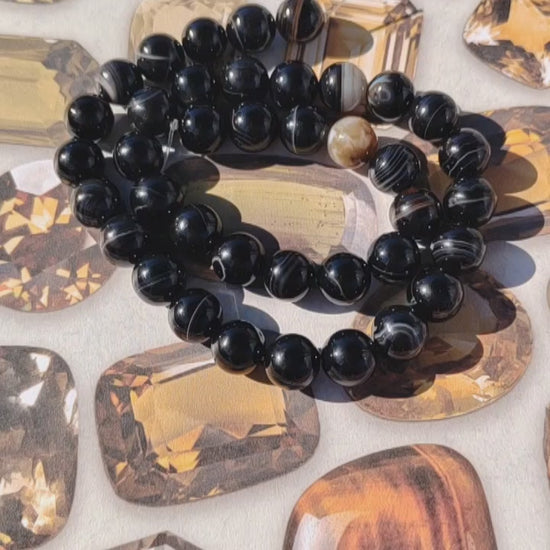 Black banded agate on a background of crystal pictures In the sun.