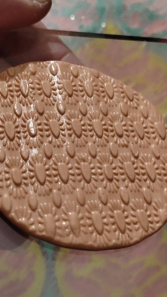 A heart and daisy design embossed in silly putty.
