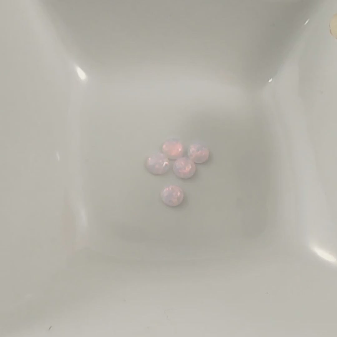 Pink opals with red flashes In a white dish