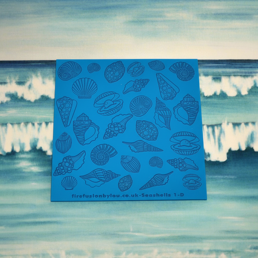 A debossed seashell texture mat with mirrored designs small and big, two sizes. use to make an impression on metal clay and polymer clay.