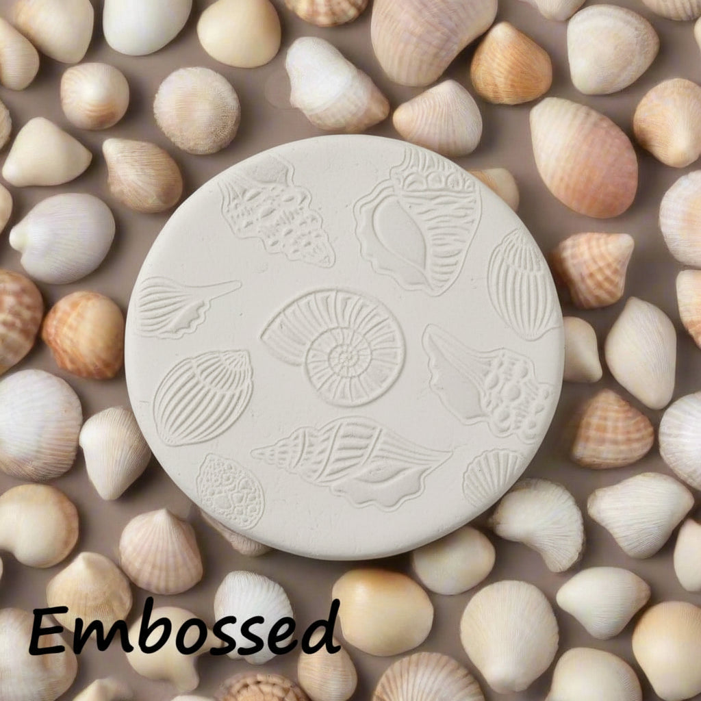 Seashells debossed in clay using an embossed texture mat. 