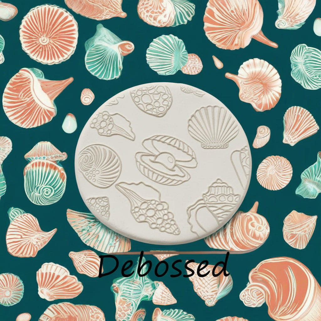 Seashells embossed in clay using a  debossed texture mat.