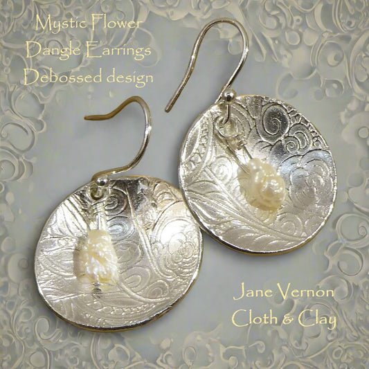 Silver 999 dangly earrings embossed with mystic mandala two texture mat design. These elegant earrings have a cream baroque drop pearl.