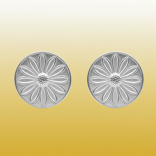 Silver floral earrings on a gold gradient background