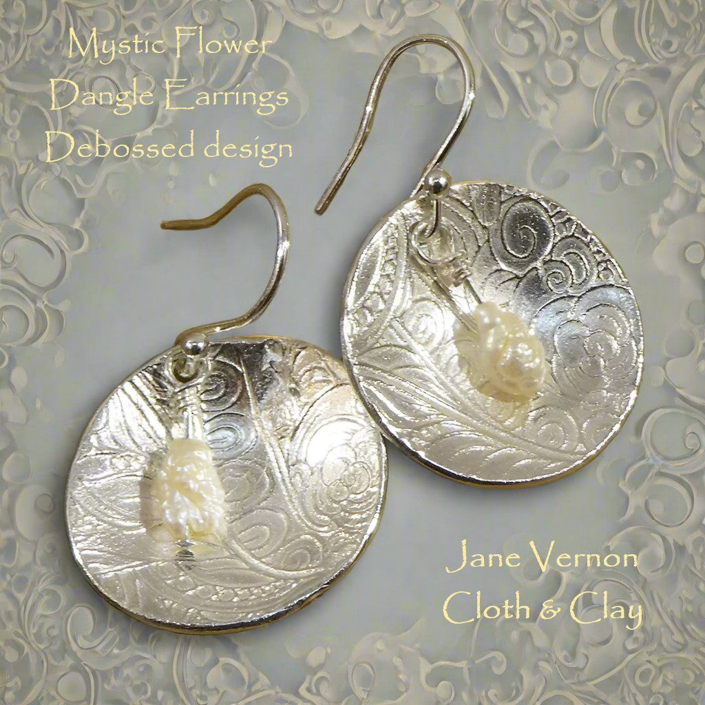 Silver 999 dangly earrings embossed with mystic mandala two texture mat design. These elegant earrings have a cream baroque drop pearl.