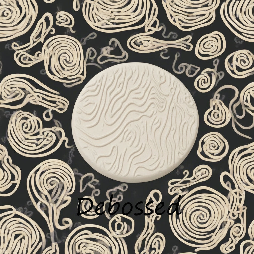 A pattern embossed in clay using a patterned debossed texture mat.