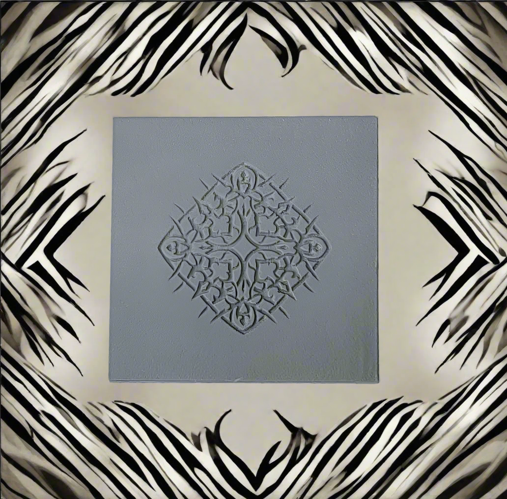 A square grey rubber diamond-shaped floral motif in the centre, surrounded by a beige background with a black-and-white zebra-stripe border design.