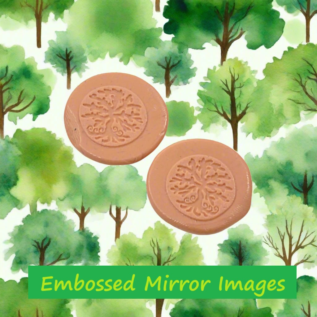 A tree debossed in silly putty Using a  embossed texture mat in grey material. This will give you an idea of what it will look like on metal clay or polymer clay