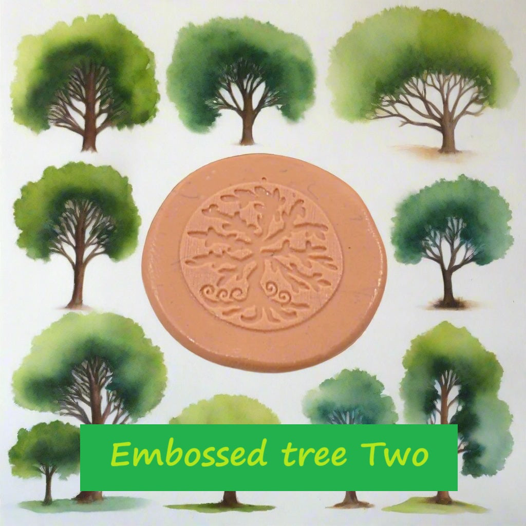 A tree debossed in silly putty Using a  embossed texture mat in grey material. This will give you an idea of what it will look like on metal clay or polymer clay