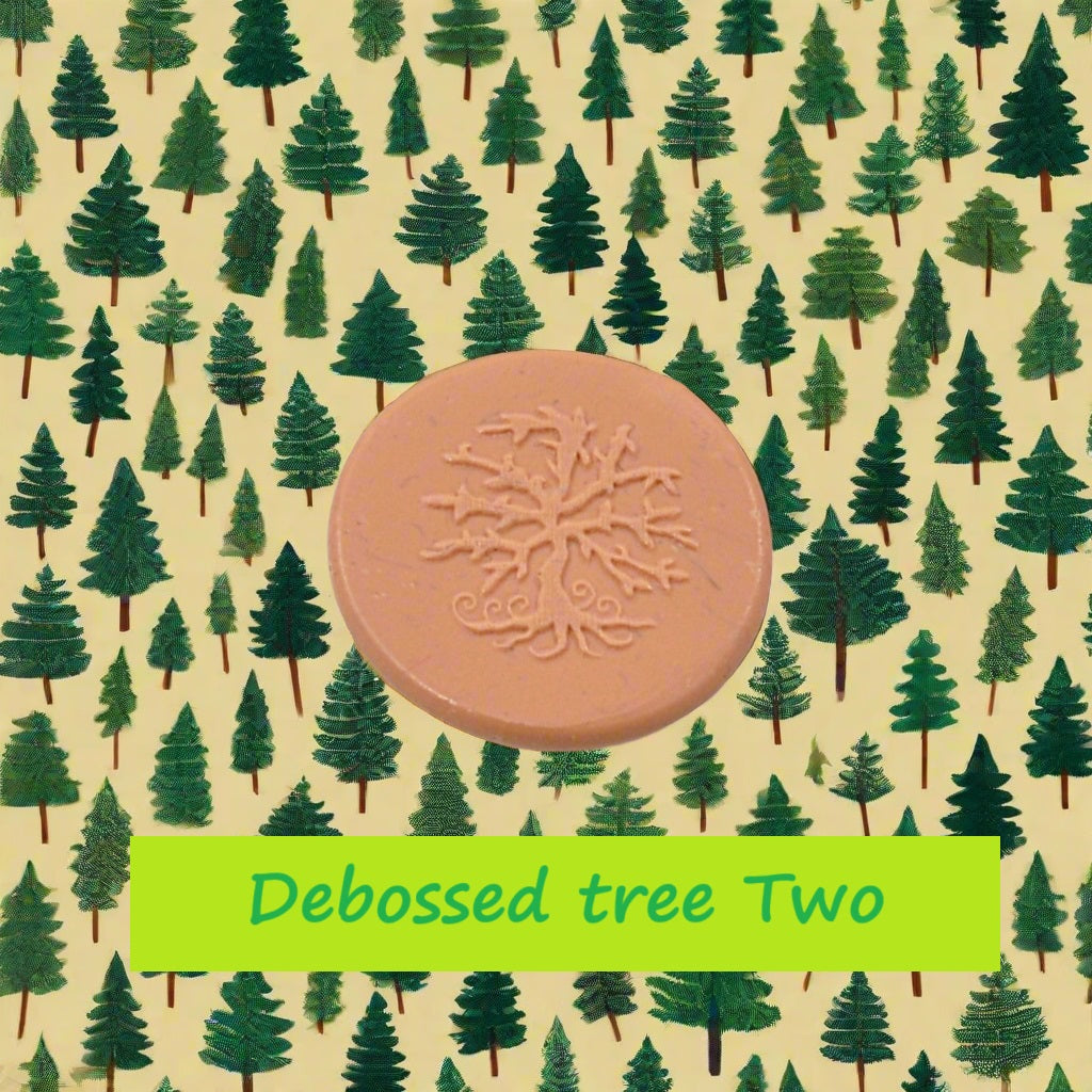 A tree embossed in silly putty Using a  debossed texture mat in grey material. This will give you an idea of what it will look like on metal clay or polymer clay