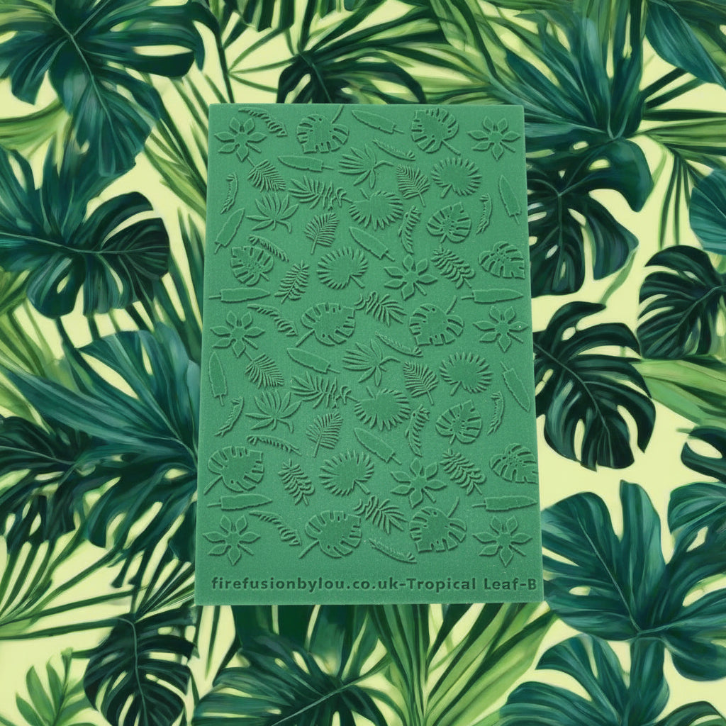 A 95 x 55 mm texture mat with small tropical leaves in a repeat pattern. Use to make a debossed impression on metal clay and polymer clay.