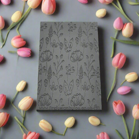 A 95 x 55 mm debossed texture mat with a flower design. Use to make a embossed impression on metal clay and polymer clay.