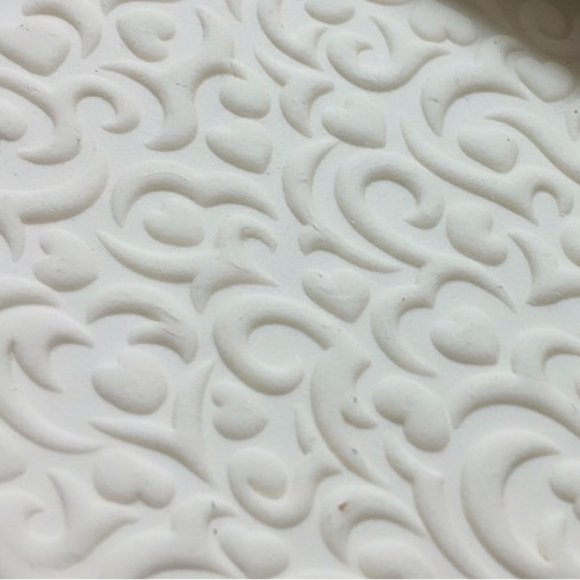 Close-up of a white textured clay with intricate patterns