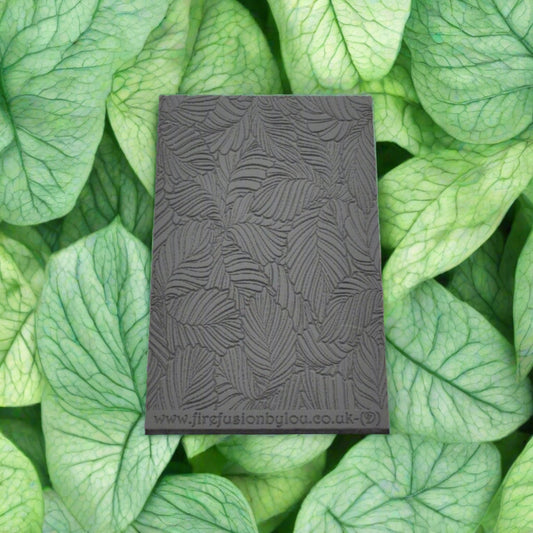 A 95 x 55 mm debossed texture mat with variegated leaves. Use to make a embossed impression on metal clay and polymer clay.