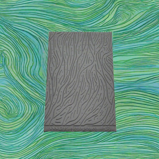A pattern debossed texture mat in grey material. This texture mat will give you an embossed effect on metal clay or polymer clay.