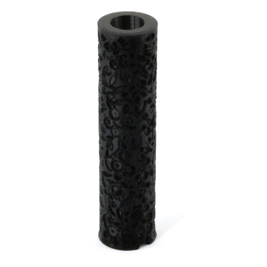 A black textured roller for metal clay or polymer clay with an ergonomic design, featuring a floral pattern on the surface.