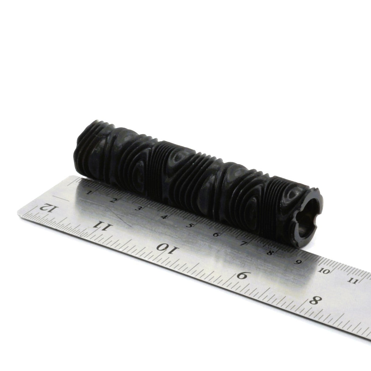 Metallic cylindrical object with a white background