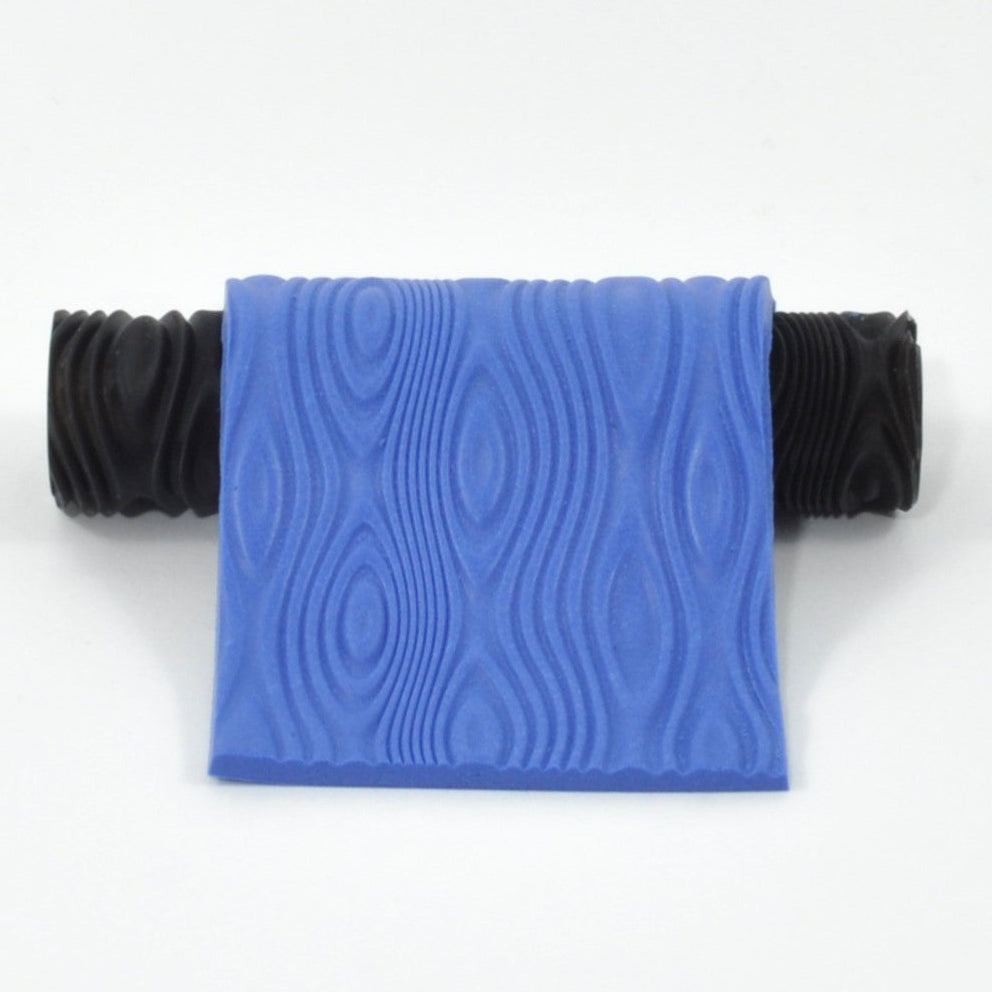 Blue wood textured polymer clay on a white background