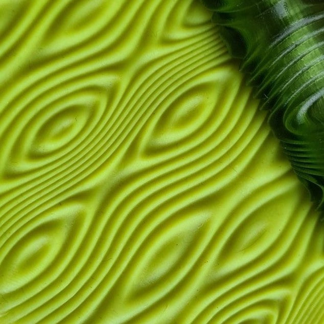 Close-up of a textured green surface with wavy patterns