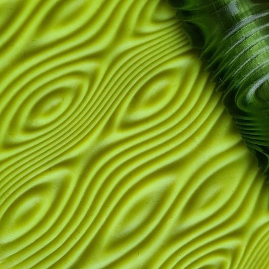 Close-up of a textured green surface with wavy patterns