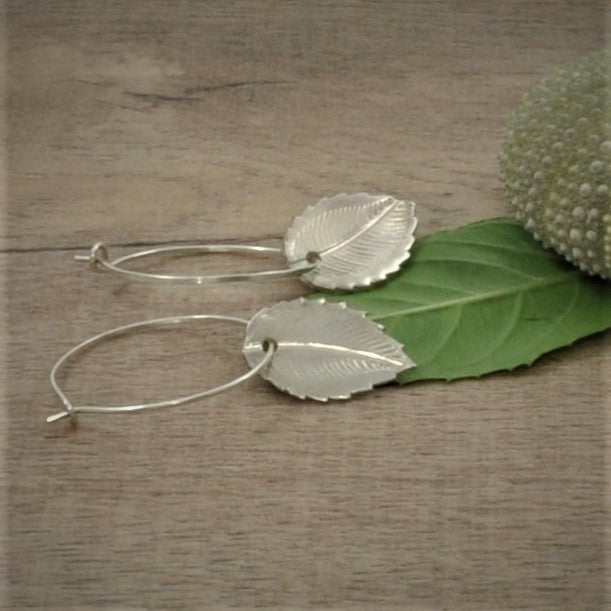 Crafted from 999 fine silver, these earrings each feature a bramble leaf-shaped charm, intricately designed in various patterns and attached to 925 silver French hooks or hoops.